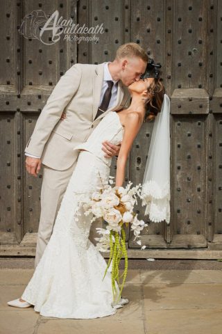 Bride and Groom Kissing by door at Norwich Castle