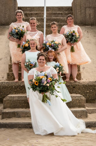 Bride and bridesmaids on beach at Mundesley Norfolk