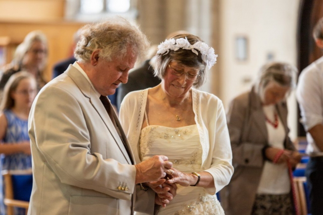 Bride and Groom exchanging rings at St Marys Church Attleborough
