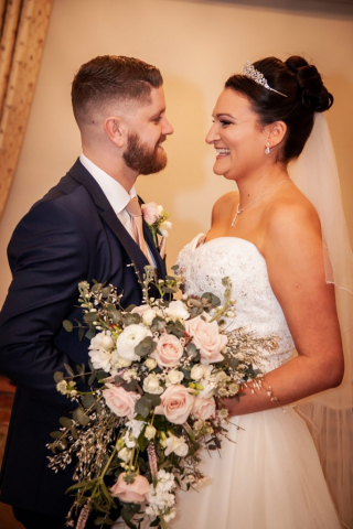 Bride and Groom loving looks at Hunters Hall Swanton Morley