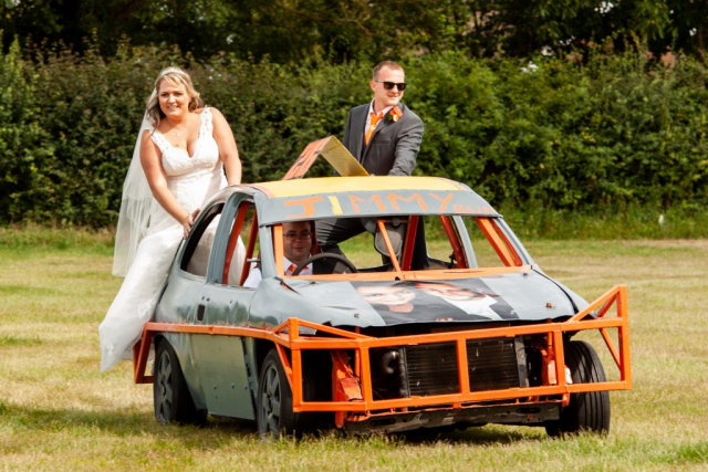 Bride and Groom riding on the back of a Stock Car