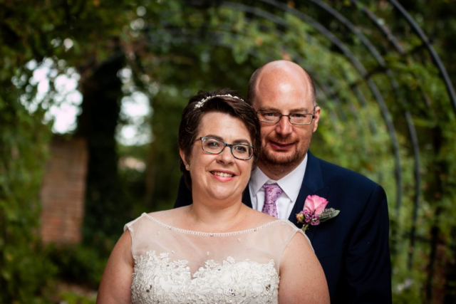Bride and groom standing in archway at The Reading Rooms Alby