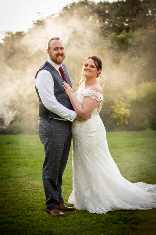 Bride and Groom embrace with smoke at Knights Hotel Kings Lynn