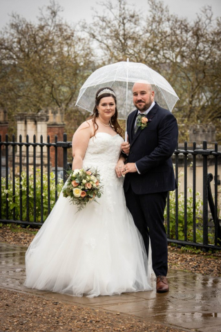 Bride and Groom under umbrella at Norwich Castle