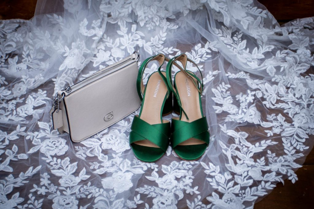Wedding shoes purse laying on veil at venue in Norwich