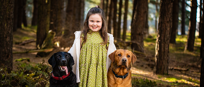 AlanBulldeathPhotographyBanner10 Young girl with her two dogs smiling at Thetford Forest Norfolk