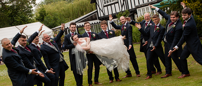 AlanBulldeathPhotographyBanner6 Bride being held up by groom best men and groomsmen
