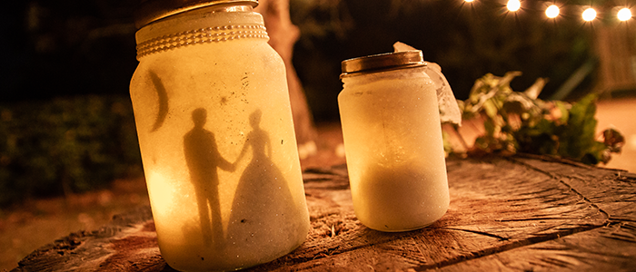 AlanBulldeathPhotographyBanner7 Glass jar decorated with bride and groom décor lit with candle light at night
