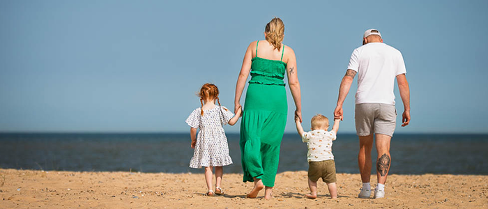 AlanBulldeathPhotographyBanner9 Family walking on the beach away from the camera towards the beach at Great Yarmouth Norfolk
